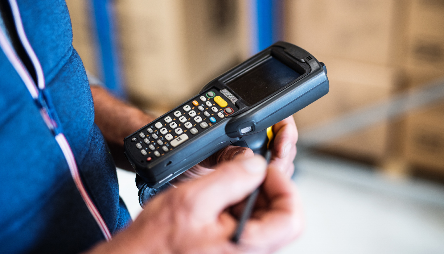 warehouse worker using bar code scanner to scanning box and analyze newly arrived goods for further placement in storage department, Working at warehouse.